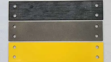 Three stacked horizontal bars: a black brushed metal top, a dark gray middle, and a bright yellow bottom. Each bar has two holes drilled at both ends.
